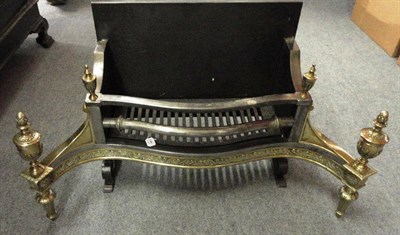 Lot 1386 - A George III Steel and Brass Fire Grate, of serpentine form with four urn shaped finials over a...