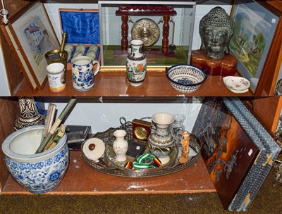 Lot 249 - Two shelves of decorative ceramics, glass and ornamental items including a Bruneian white metal and