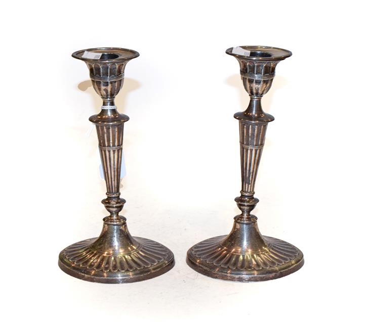 Lot 303 - A pair of George V silver candlesticks, by Hawksworth, Eyre and Co. Ltd., Sheffield, 1915, each...