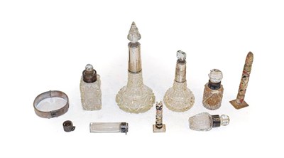 Lot 321 - A quantity of silver mounted glass scent bottles, a silver bangle and two carved bone miniature...