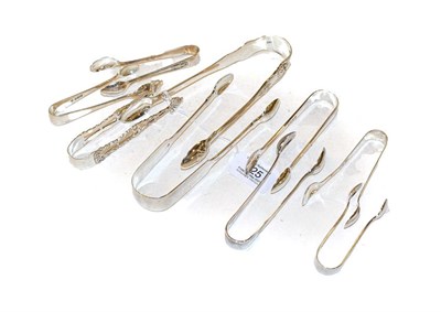 Lot 325 - Seven pairs of William IV, Victorian and later silver sugar tongs, various patterns, including...