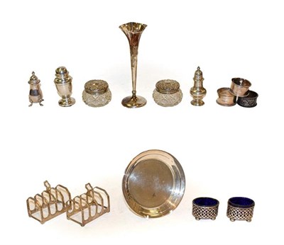 Lot 335 - A collection of assorted silver, including three various napkin-rings, a pair of five bar toast...