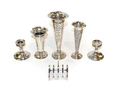 Lot 336 - A collection of assorted silver including three vases, a toast rack and a pair of candlesticks,...