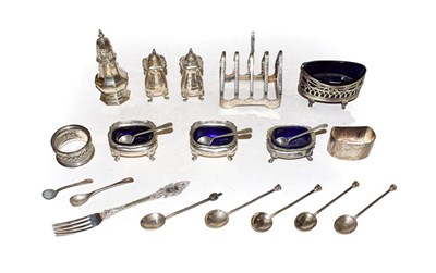 Lot 343 - A selection of silver including toast rack, four salts with blue glass liners, one pepper, two...