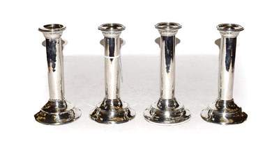 Lot 351 - A set of four Edward VII silver candlesticks, by Williams (Birmingham) Ltd., Birmingham, 1908,...