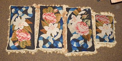 Lot 385 - Four woolwork cushions of floral design, worked in black, blue, red and cream threads with...