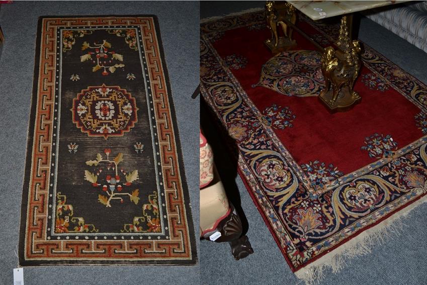 Lot 1100 - An Indian Rug, the blood red field centred