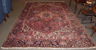 Lot 1103 - A Heriz Carpet, the soft tomato field with central medallion framed by spandrels and indigo...