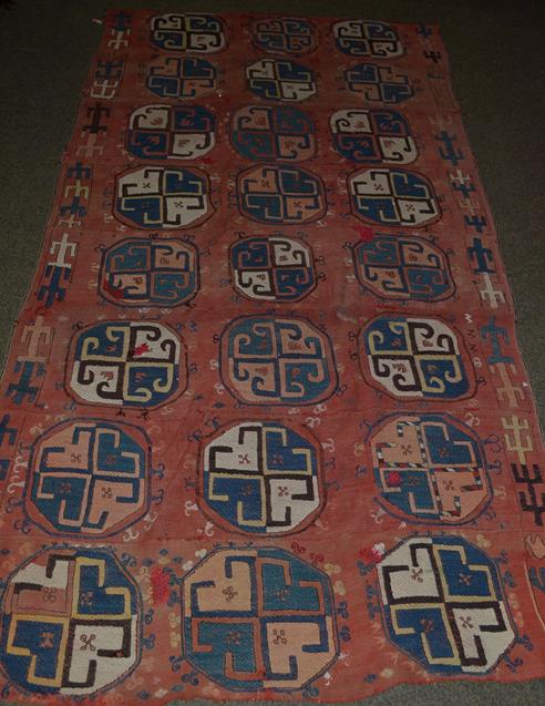 Lot 1110 - An Usbek flat weave rug, the faded madder field with a column of elephant foot guls, 262cm by 137cm
