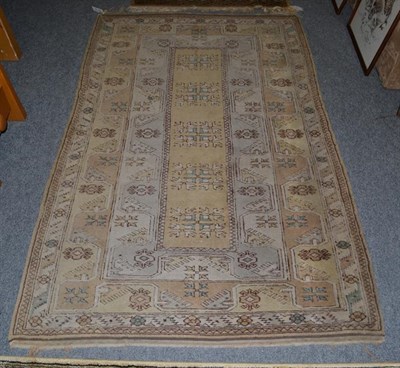 Lot 1112 - A Lahore Bukhara Carpet, the field with columns of guls enclosed by multiple borders, 270 by 189cm
