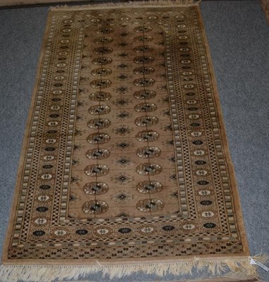 Lot 1112 - A Lahore Bukhara Carpet, the field with columns of guls enclosed by multiple borders, 270 by 189cm