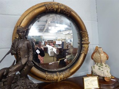 Lot 1119 - A Regency convex circular mirror in gilt frame with ebonised slip, 57cm dia.