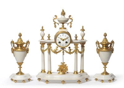 Lot 1419 - A White Marble and Gilt Metal Mounted Striking Mantel Clock with Garniture, circa 1890, the portico