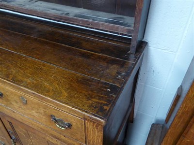 Lot 1123 - An early 19th century oak dresser and rack fitted with later castors, rack associated or cut...