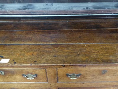 Lot 1123 - An early 19th century oak dresser and rack fitted with later castors, rack associated or cut...