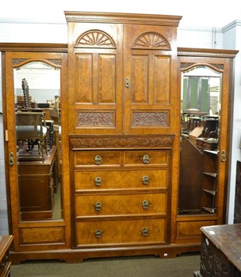 Lot 1128 - A substantial Victorian walnut break-front mirrored wardrobe, the central section fitted with...