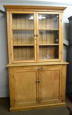 Lot 1129 - A Victorian pine house keepers cupboard, with glazed top, 130cm by 50cm, 219cm