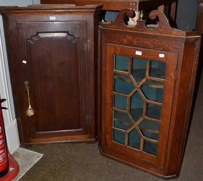 Lot 1134 - A George III panelled oak hanging corner cupboard, 73cm by 39cm by 112cm together with a later...