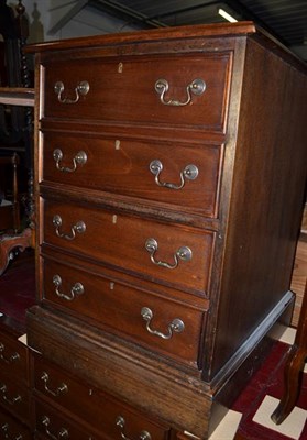 Lot 1139 - A reproduction red leather inset mahogany veneered six-drawer filing cabinet, the six drawers...