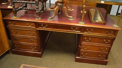 Lot 1140 - A red leather inset mahogany pedestal partners desk, each side fitted with three frieze drawers...