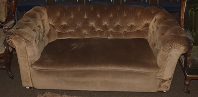 Lot 1142 - A buttoned Chesterfield style drop arm sofa, 170cm by 80cm by 70cm