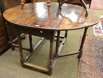 Lot 1144 - An early 18th century oak gateleg dining table, 135cm by 118cm by 75cm