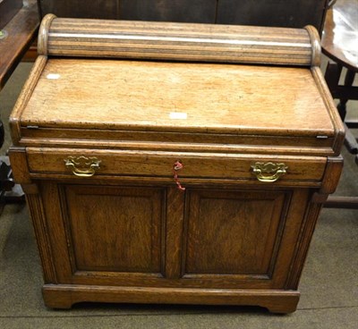 Lot 1146 - An early 20th century oak desk of small proportions, the drawer opening a tambour mechanism to...