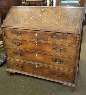 Lot 1149 - A George III cross banded and inlaid oak bureau with fully fitted interior, 13cm by 56cm by 115cm