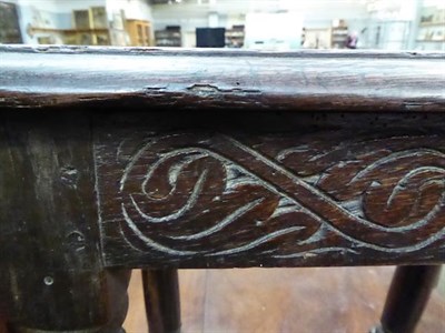 Lot 1152 - An 18th century oak joint stool with scroll carved frieze, initialled W.H, on splayed turned...