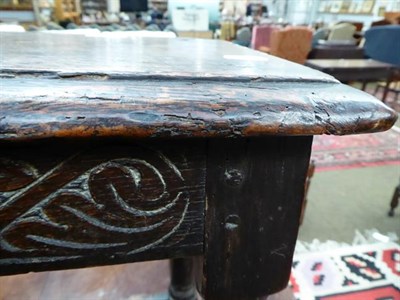 Lot 1152 - An 18th century oak joint stool with scroll carved frieze, initialled W.H, on splayed turned...