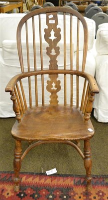 Lot 1165 - A 19th century elm Windsor chair with crinoline stretcher