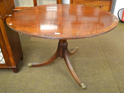 Lot 1183 - A 19th century mahogany breakfast table crossbanded in Rosewood, raised on a reeded tripod with...