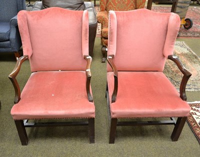 Lot 1185 - A pair of Georgian style mahogany framed wing back armchairs