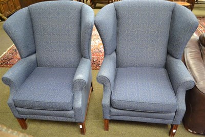 Lot 1188 - A pair of wingback chairs upholstered in blue fabric, possibly Duresta, 82cm by 75cm by 110cm