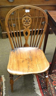 Lot 1199 - A 19th century elm Windsor rocking chair together with a 19th century yew and elm wheel back...
