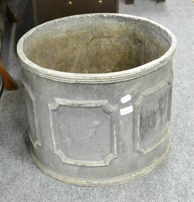 Lot 1202 - A Georgian style lead garden planter of cylindrical form and decorated with notched panels,...