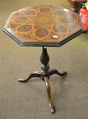 Lot 1210 - A 19th century ebonised and painted tripod table, the table top decorated with eight figures within