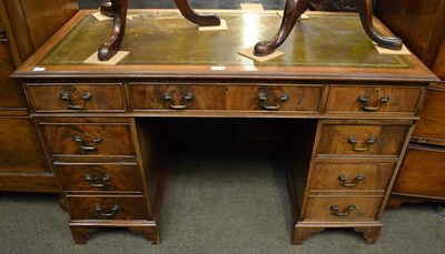 Lot 1215 - A green leather inset mahogany knee hole desk, 121cm by 60cm by 74cm