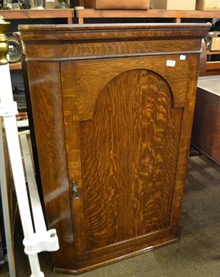 Lot 1227 - A Georgian mahogany bow-fronted corner cupboard, 69cm by 49cm by 105cm, together with an oak...