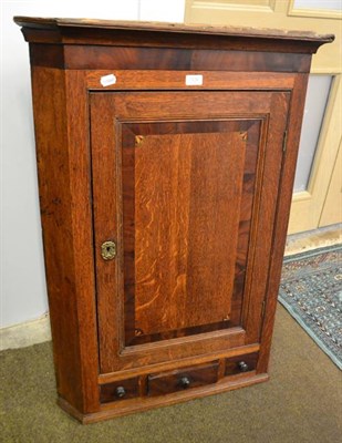 Lot 1232 - A George III cross-banded and inlaid oak straight front hanging corner cupboard, 76cm by 41cm...