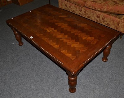 Lot 1256 - A modern oak parquet top coffee table with bobbin turned mouldings and baluster supports, 127cm...