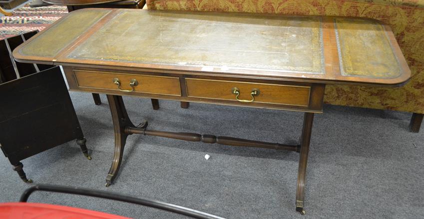 Lot 1260 - An early 20th century mahogany leather topped two drawer sofa table with reeded sabre supports...