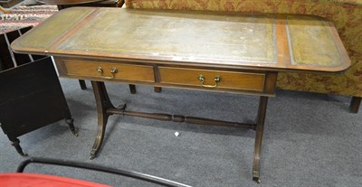 Lot 1260 - An early 20th century mahogany leather topped two drawer sofa table with reeded sabre supports...