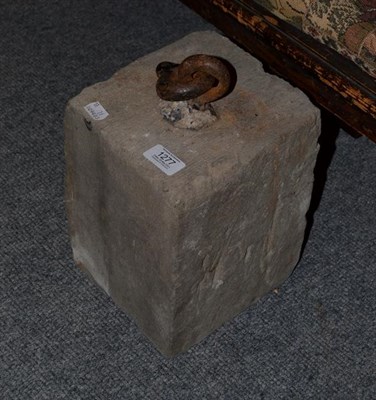 Lot 1277 - A square section stone fitted with an iron bullring, 18cm by 20cm by 25cm