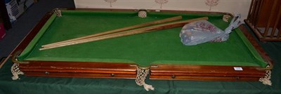 Lot 1278 - An early 20th century table top snooker table, 132cm by 71cm with cues and balls