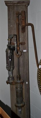 Lot 1286 - A water pump mounted on an oak board, 199cm high