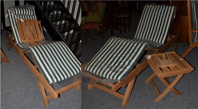 Lot 1299 - A pair of garden sun loungers with adjustable frame and matching side tables/ stools by TEAK...