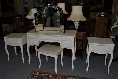 Lot 1318 - A Laura Ashley cream dressing table, 110cm by 46cm by 78cm, with matching bedsides, 62cm by 42cm by