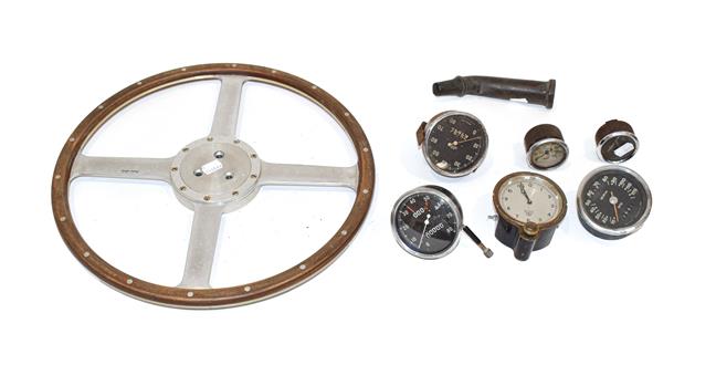 Lot 98 - A Moto-Lita Four-Spoke Riveted Metal Steering Wheel, six assorted car dials, and a solid brass...