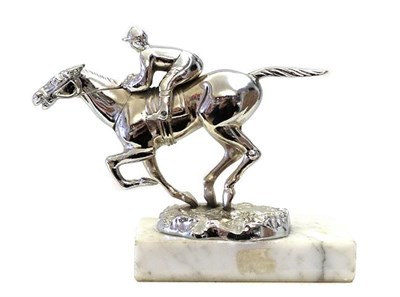 Lot 156 - A Chrome on Brass Accessory Car Mascot, as a jockey on horseback, mounted on a grey rectangular...